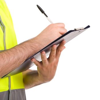 man in yellow vest holding clip board